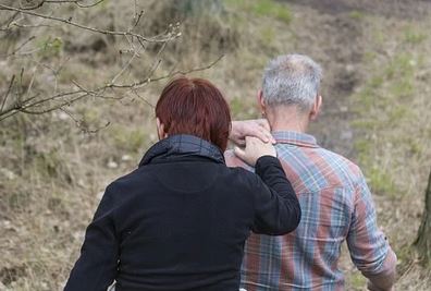 Foto de dos personas de espaldas dándose la mano
